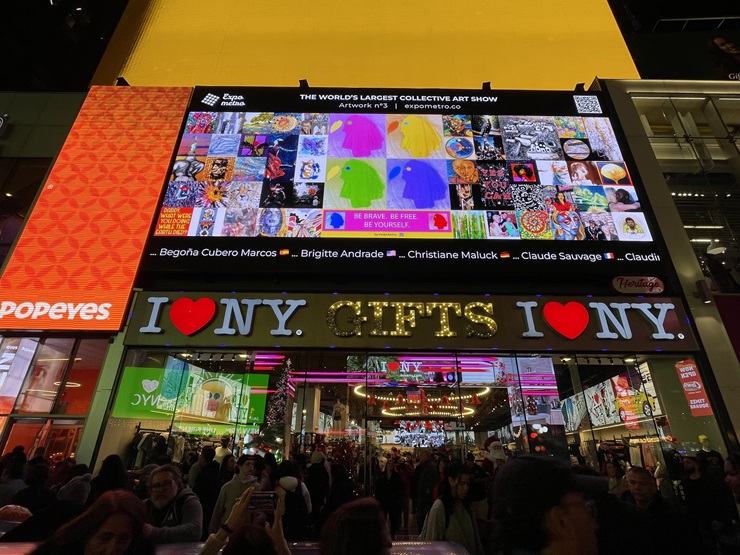 Visitors take photos of the 10th edition of Expo Metro on a giant LED Times Square Billboard on Dec. 2, 2023. The Expo Metro Interactive Art Train comes to areas of Miami and Miami Beach starting Thursday, Dec. 7 to Saturday, Dec. 9.