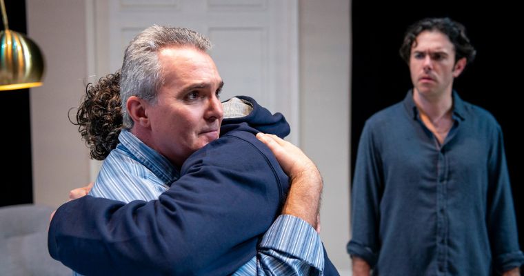 Wayne LeGette as Leo embraces Jeff Brackett as Ben while Ben Katz as Jake looks on. (Photo by Justin Namon)