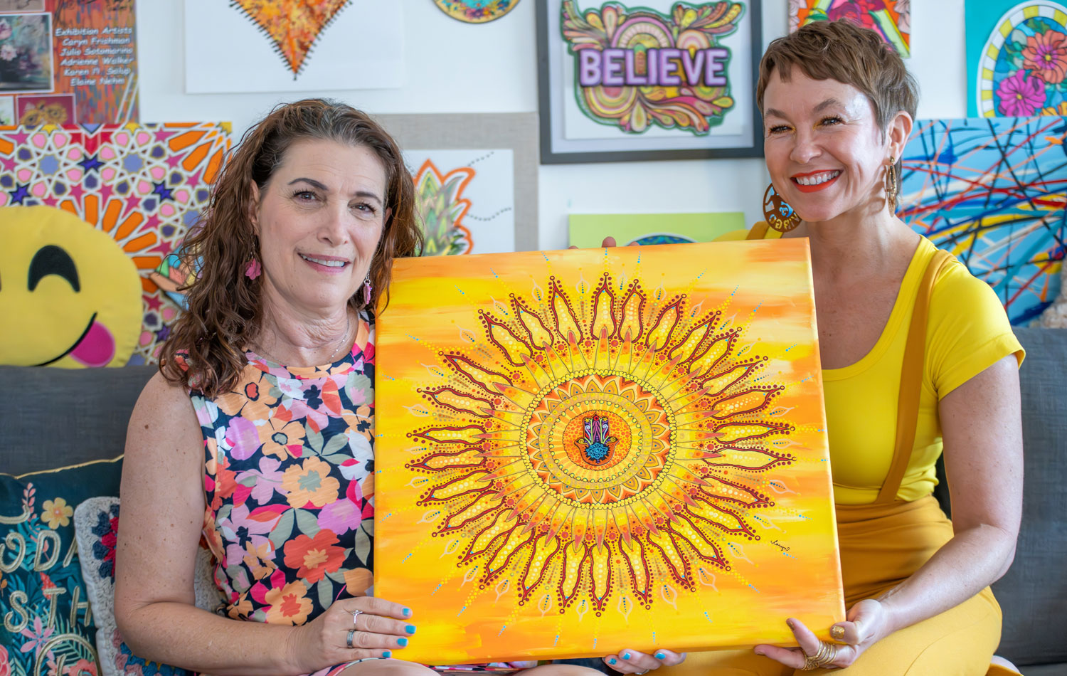 Caryn Frishman and Ashley Smith pose with the art piece Caryn created, inspired by Ashley as part of the Arsht Center's Brushes with Cancer program. (Photo by Gregory Reed)