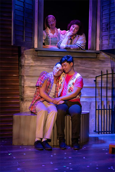 Margot Moreland and Jeni Hacker play moms who are happy that their sons, Kevin Hincapie and Jonny Lee Jr., have fallen in love. (Photo by Matthew Tippins for Island City Stage)