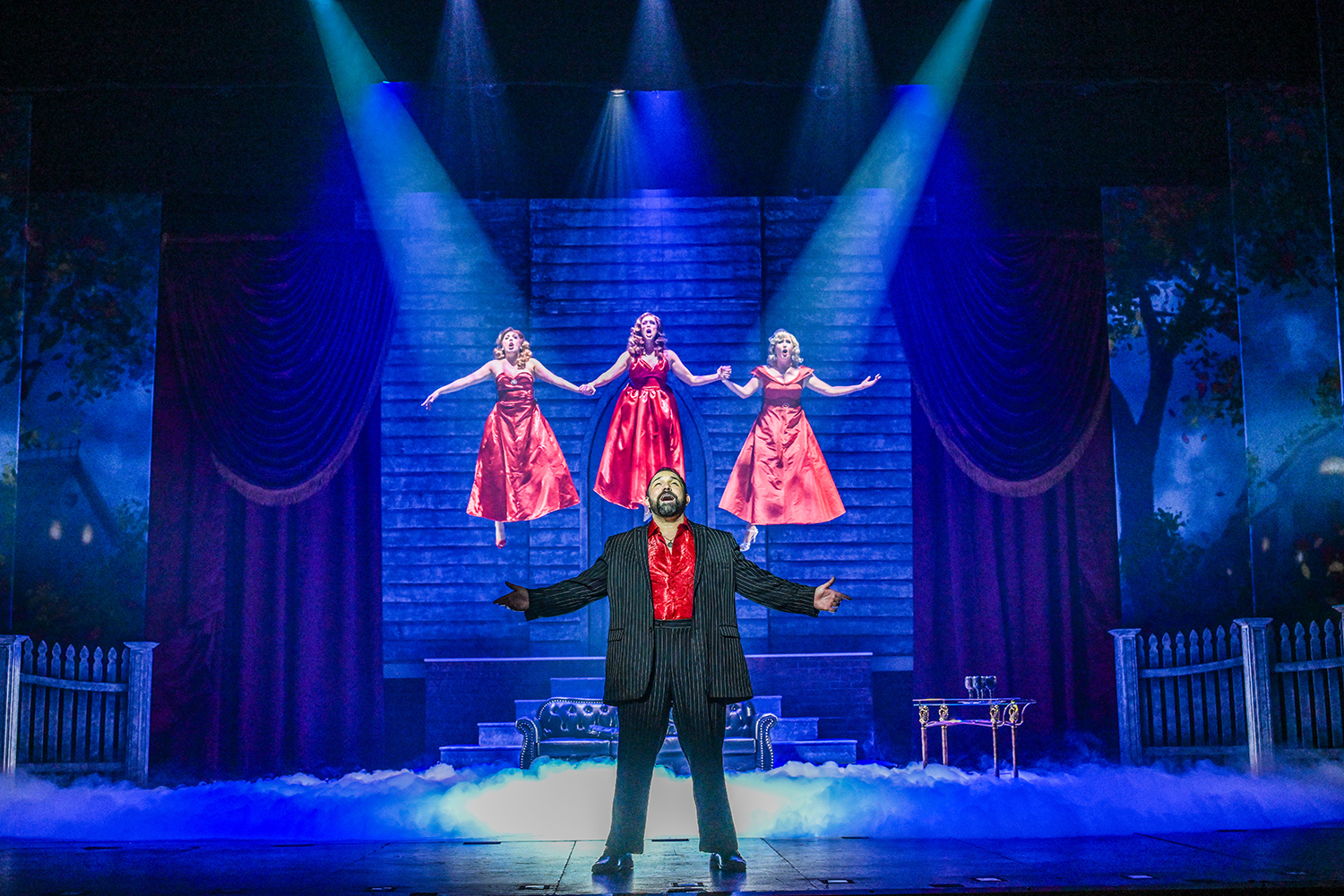 Philip Bryan as Daryl Van Horne (Philip Bryan), front. Back, from left, Leah Sessa as Jane, Gail Bennett as Alexandra and Lindsey Corey as Sukie. (Photo by Ron Elkman)